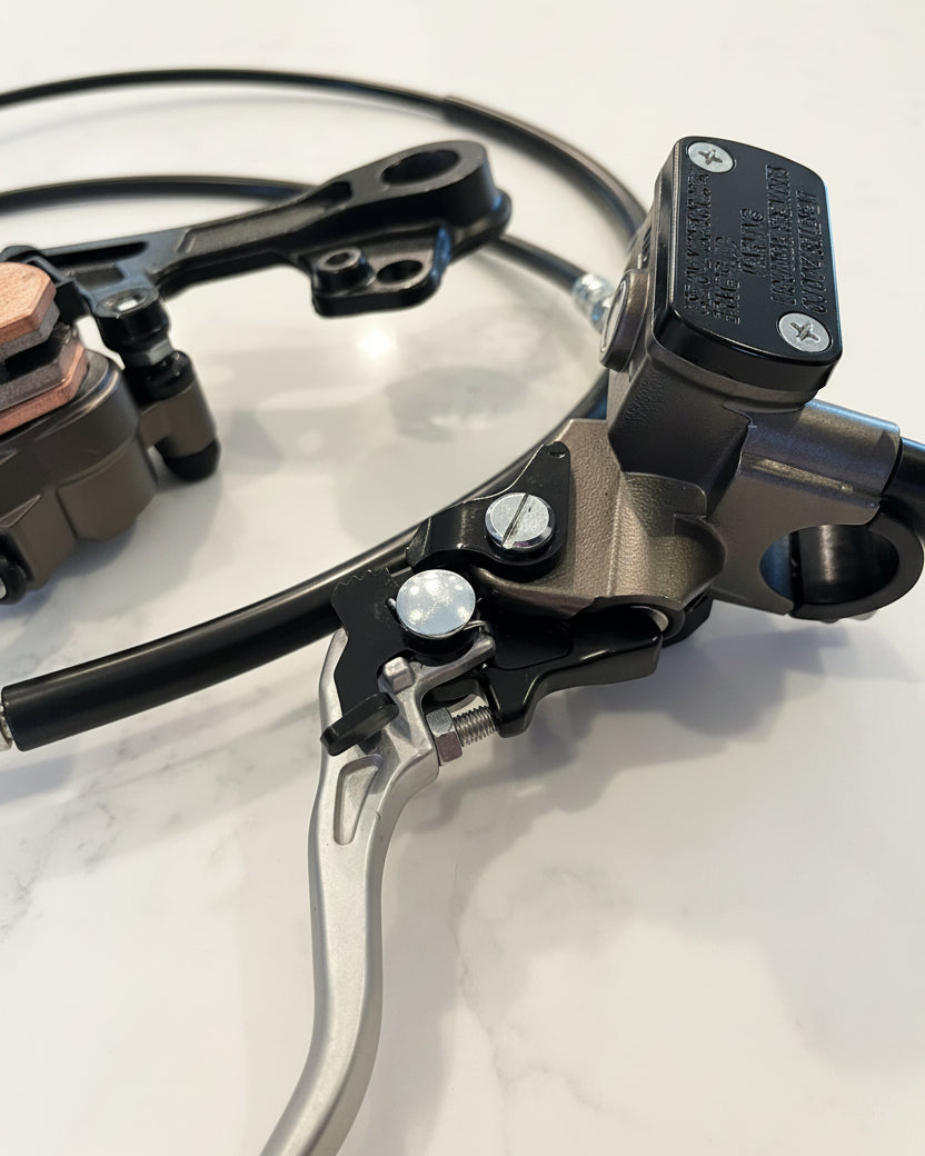 Surron Ultra Bee brake master cylinder reservoir cap and spec label detail